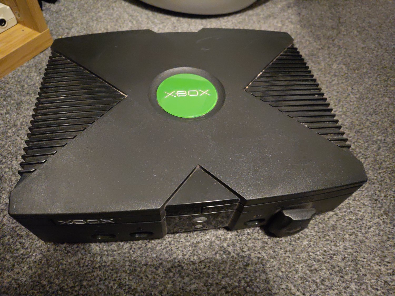 Black games console with a large 'X' shape in the top