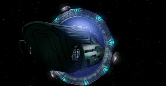 Image from Stargate: Atlantis showing a spaceship called "puddle jumper" pass through a stargate