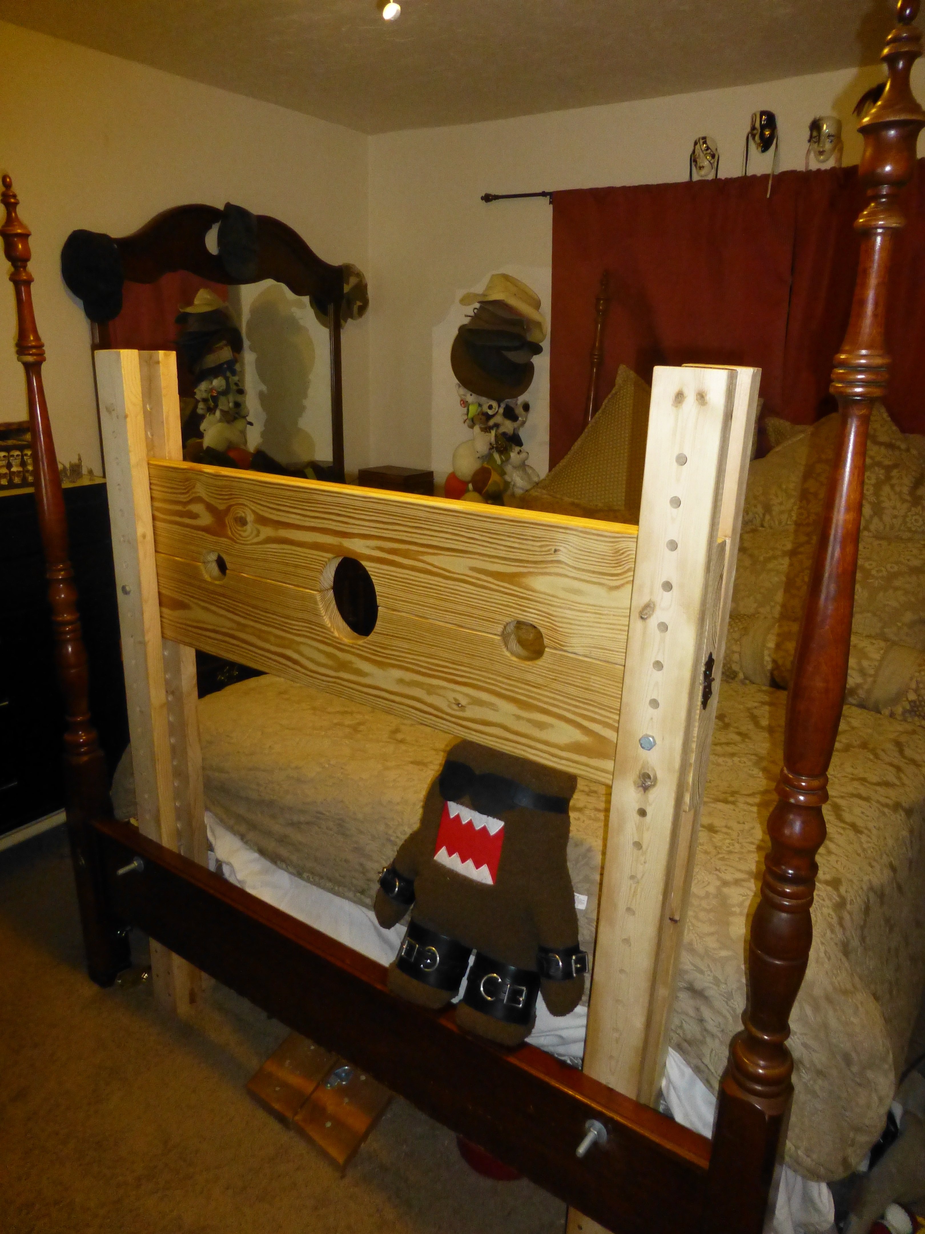 A pillory attached to a bed